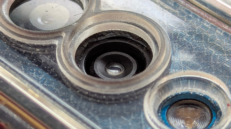 A close-up of a dirty smartphone camera lens