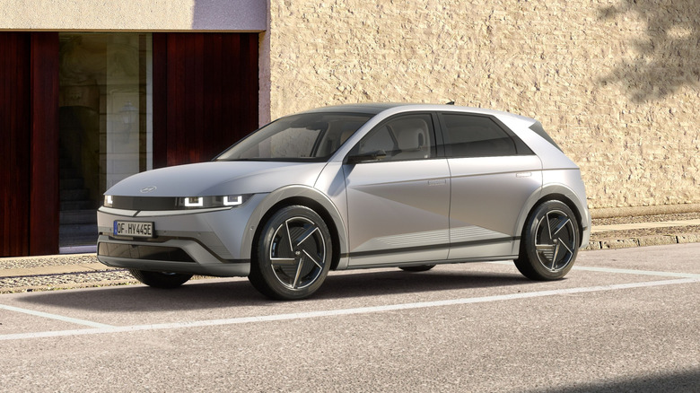 A silver Hyundai Ioniq 5 parked beside a building