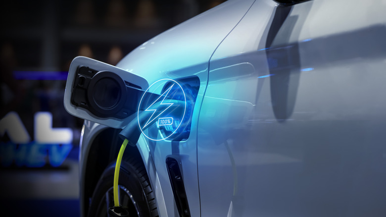 A charging electric car overlaid with a blue charging icon