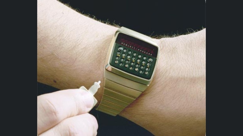 A person operating an HP-01 wristwatch calculator.