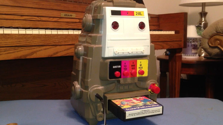 A Mego 2-XL robot in front of a piano.