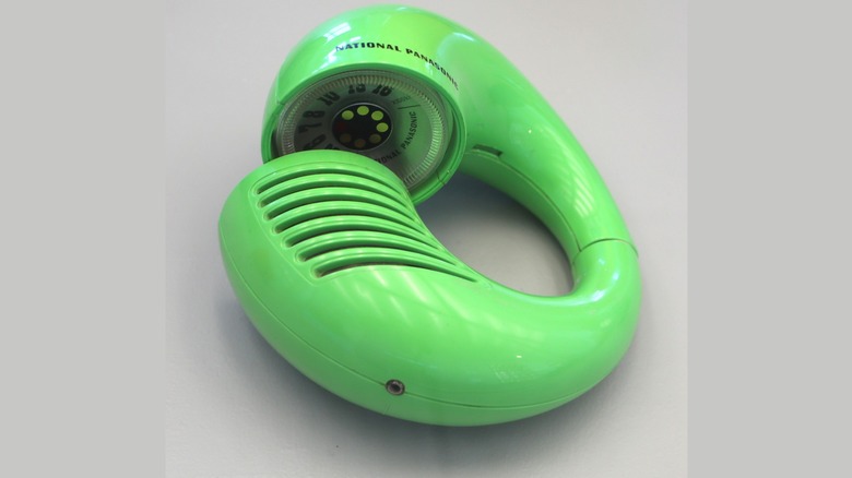 A green Panasonic Toot-a-Loop partially twisted isolated on a ligh background.