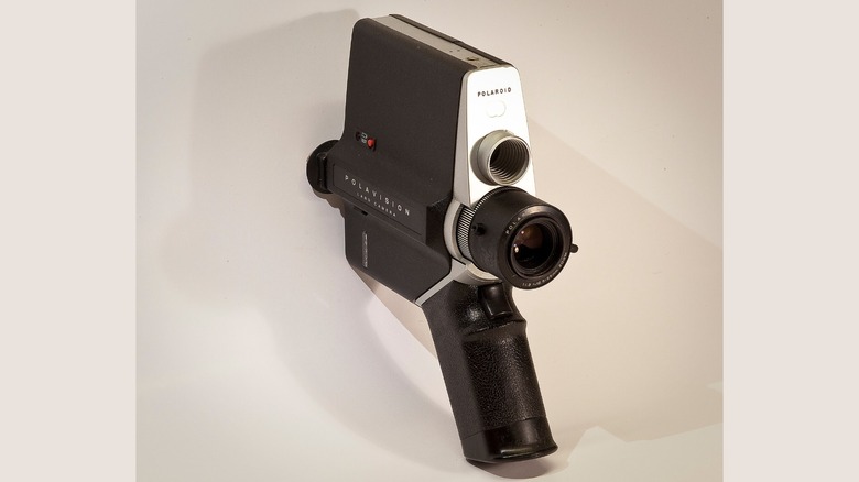 A Polaroid Polavision camera against a light gray background.