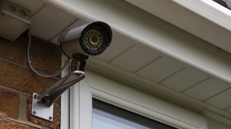 A CCTV mounted on the exterior of a brick house