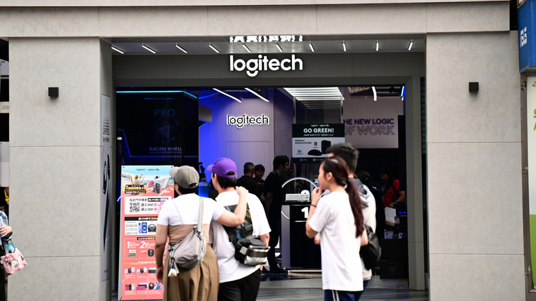 People in front of a Logitech store.