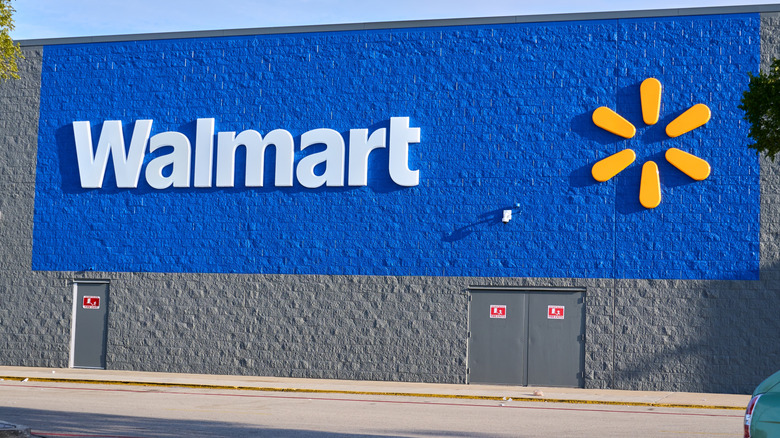 The Walmart logo on the side of a physical store.