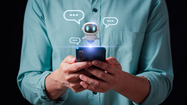 A person uses a smartphone with a representation of a chatbot floating above it.