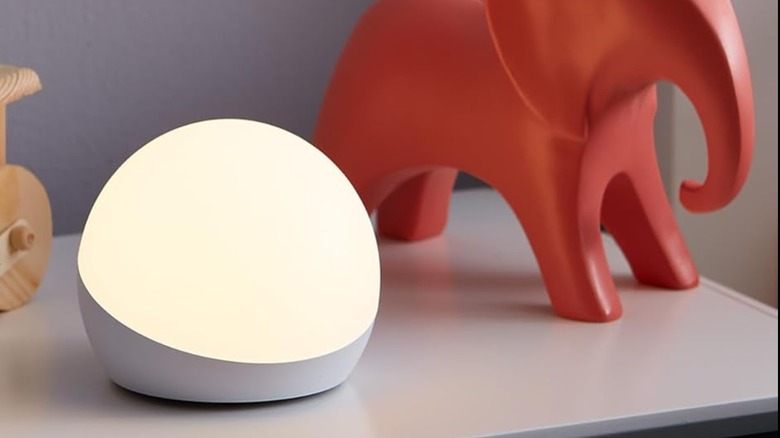Amazon Echo Glow on drawers next to wooden elephant