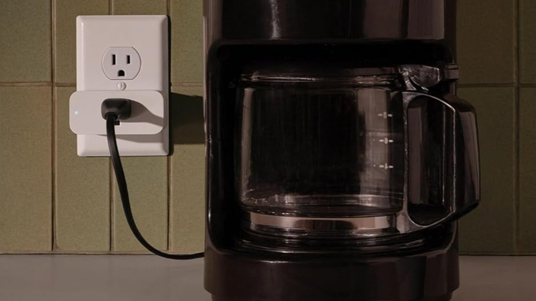 Amazon Smart plug in a wall socket connected to coffee maker