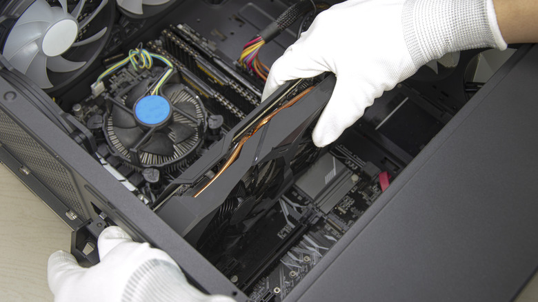 A graphics card being installed into a desktop computer.