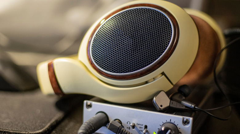 A close-up of headphones and a headphone amplifier DAC