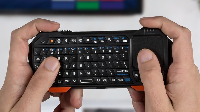 Portable wireless keyboard in hand