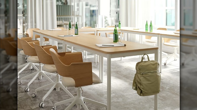 Multiple conference chairs placed against a desk.