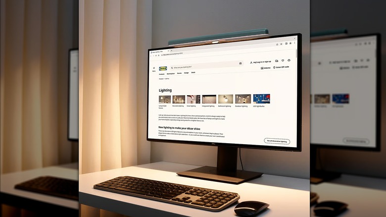 A LED lamp mounted on a monitor alongside a keyboard and mouse.