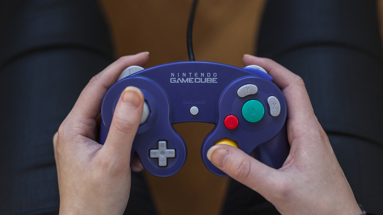 A pair of hands holding the Nintendo GameCube controller