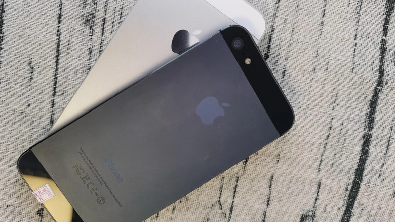 An iPhone 5 in Black and Slate; the phone is colored gray in the middle while the top and bottom are black