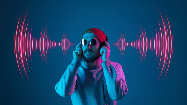 A man is shown with graphics of soundwaves on either side of his head.