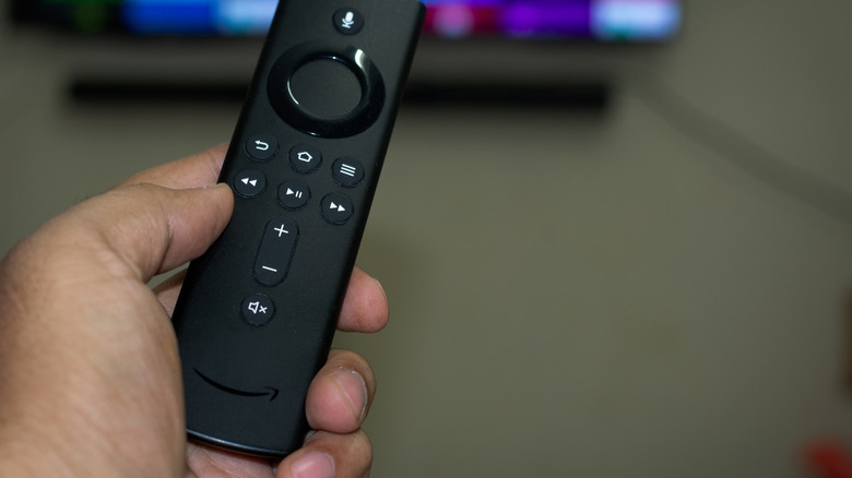Holding a Fire TV remote