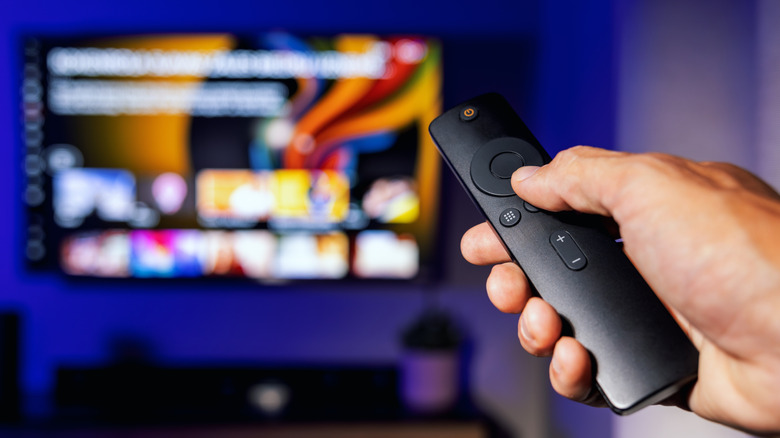 A remote being used to operate a Fire TV device