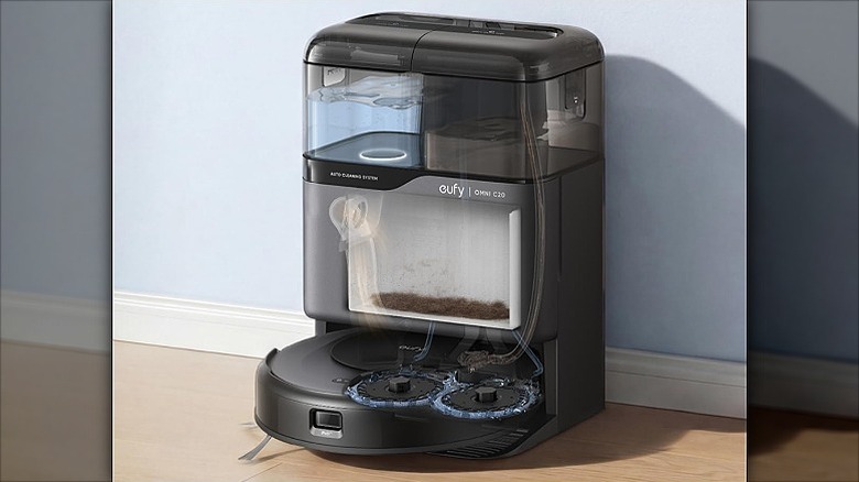 Robot vacuum docking station containing clean and dirty water in respective tanks