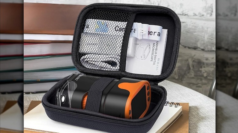 Portable microscope and manual packed inside a black EVA case.