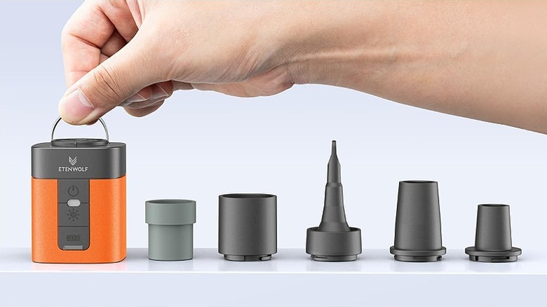 Mini air pump placed beside five different nozzles.
