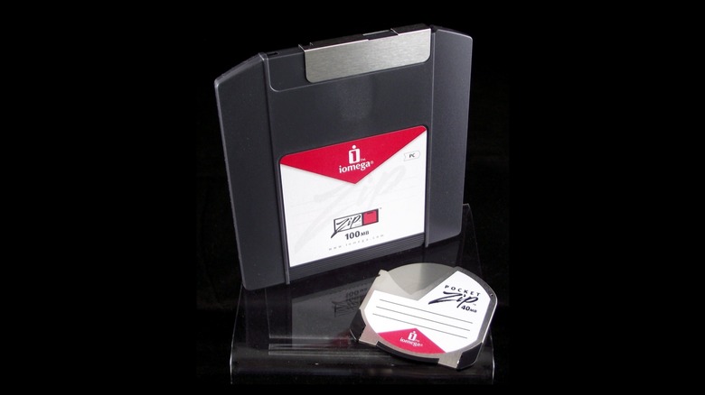 An Iomega Zip disk next to a PocketZip disk, isolated on a black background.