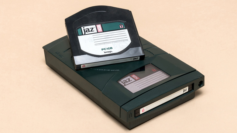 An Iomega Jaz drive with a disk on top against a beige background.