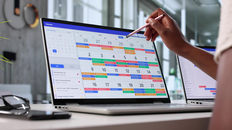 Somebody looking at a calendar on their laptop.