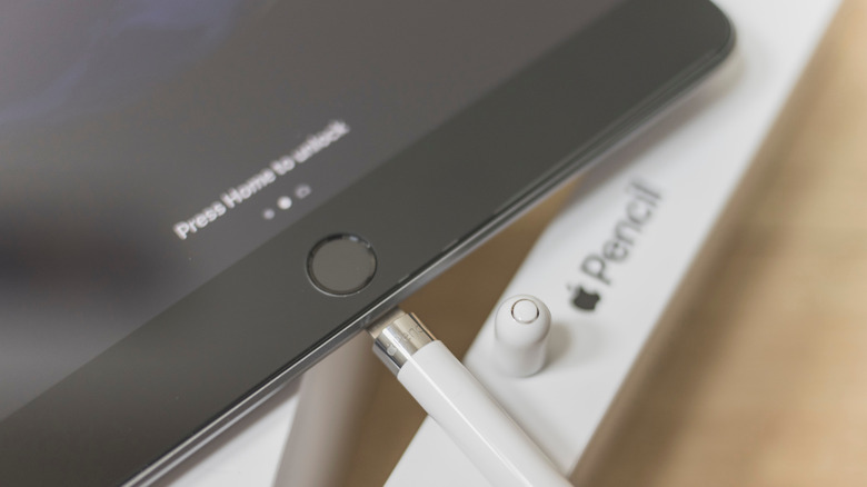 Apple Pencil plugged into the charging port of an iPad