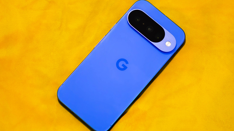 An Indigo Blue Google Pixel 10 on a yellow surface
