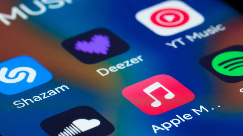 Close-up view of a smartphone screen displaying popular music streaming and audio applications