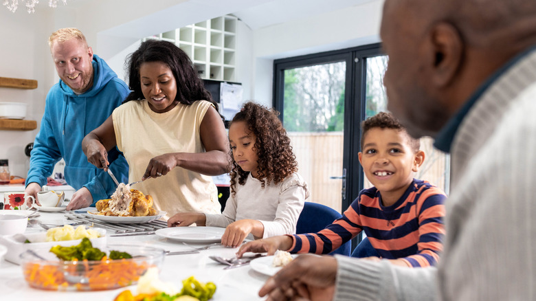 A multigeneration family sitting at dining table