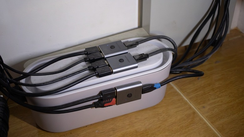 a cable management box with several cables leading into it