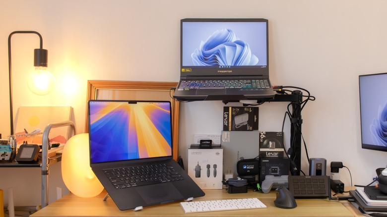 the author's two laptops mounted on stands/arms