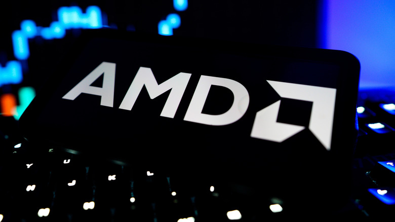 The AMD logo in front of a laptop