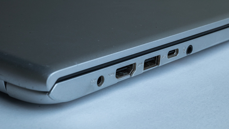 The side of a laptop showing ports, including a headphone jack.