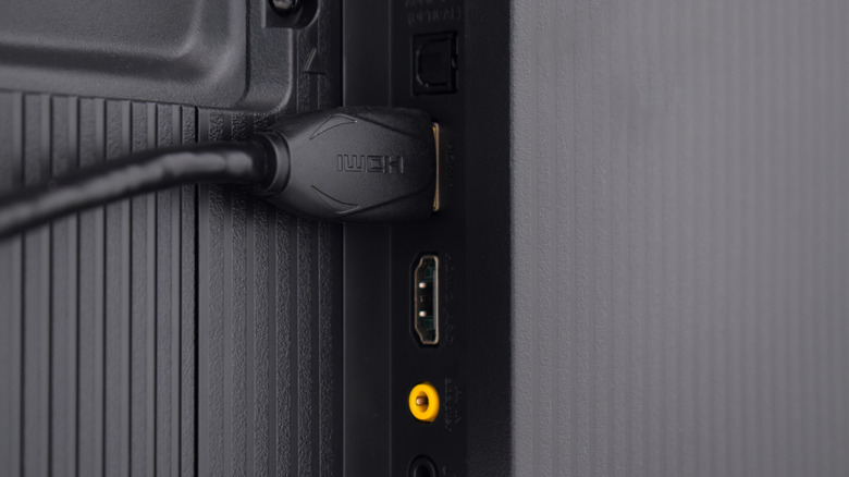 Close up of HDMI cable connected to back of TV.