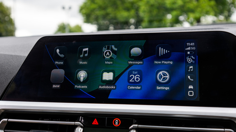 An infotainment screen displaying CarPlay with the Liquid Glass theme