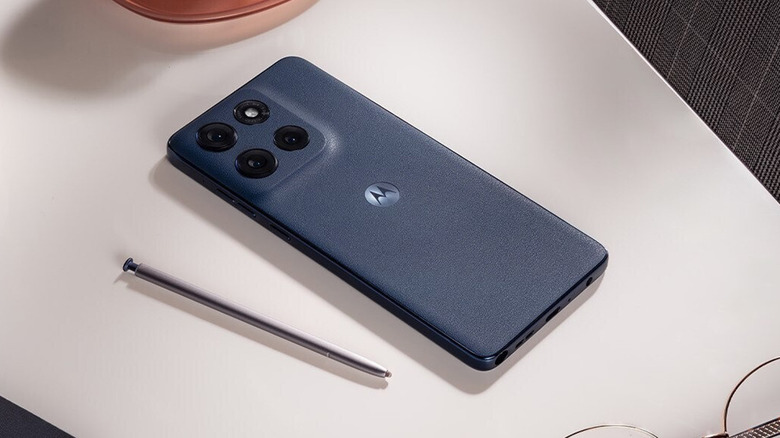 The Motorola Moto G Stylus (2025) on a table face down with a stylus beside it.