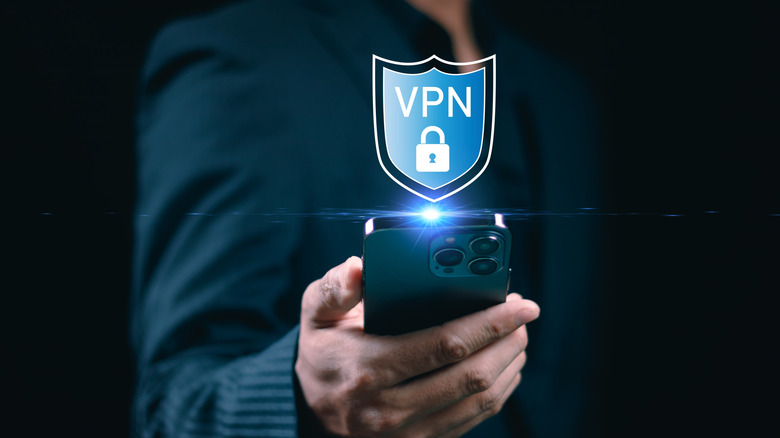 VPN logo above smartphone in use.