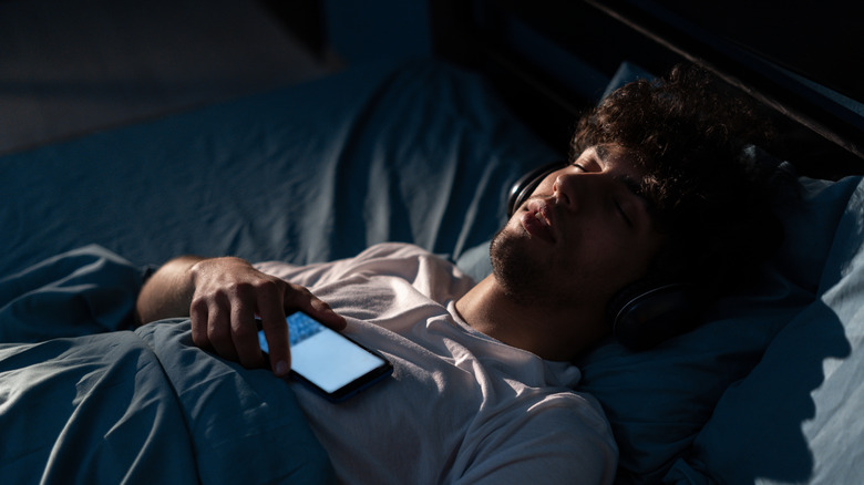 Person wearing headphones while sleeping