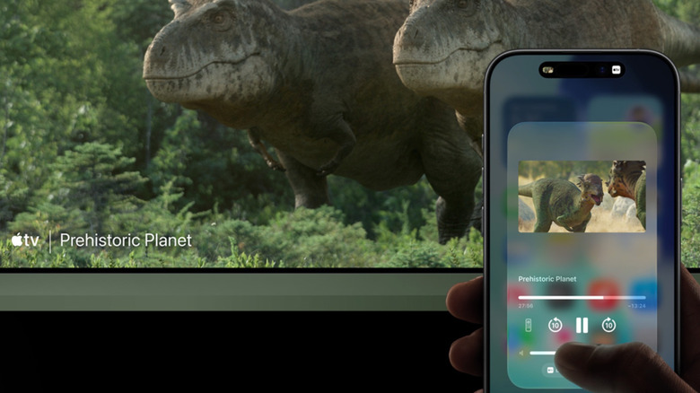 A person using AirPlay on an iPhone to cast a TV show to a smart TV.