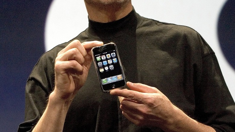 Steve Jobs holding the first iPhone in 2007