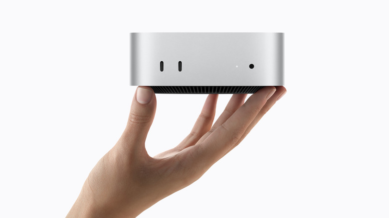 Person holding new Mac mini 2026 model