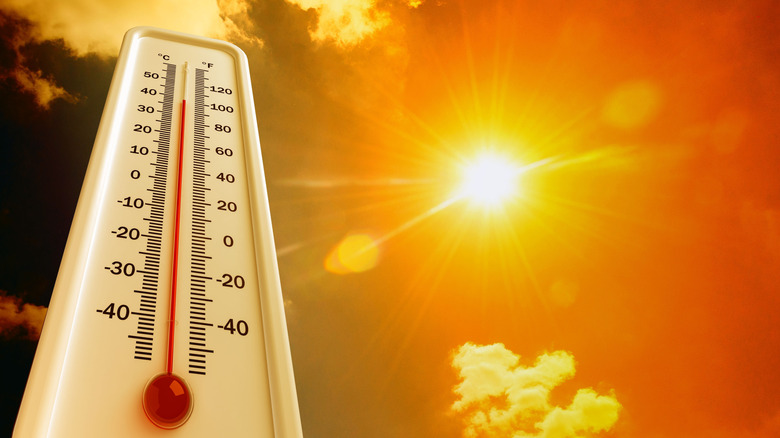 a thermometer next to a hot sun