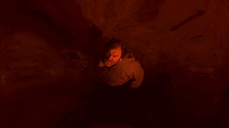 Red shot of Brendan Gleeson looking up towards the viewer