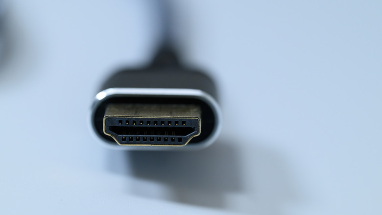 Closeup of an HDMI connector plug against a light blue background