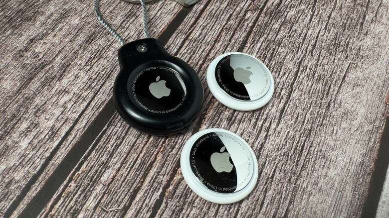 First-generation Apple AirTags are placed on a table.
