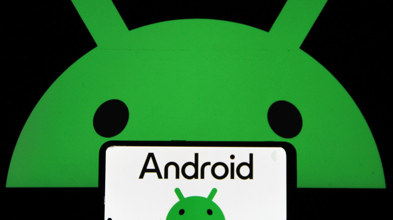 android logo on white background on smartphone with larger version of logo appearing in background